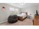 Bedroom with a full-sized bed, a beanbag chair, and a window view at 2157 Blue Iris Way, Zebulon, NC 27597
