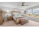 Bedroom with a rustic wood bed frame, matching nightstands, and neutral decor at 2157 Blue Iris Way, Zebulon, NC 27597