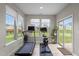 Bright exercise room featuring multiple windows, a treadmill, and an exercise bike at 2157 Blue Iris Way, Zebulon, NC 27597