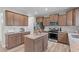 Modern kitchen featuring a center island, stainless steel appliances, and ample cabinet space at 2157 Blue Iris Way, Zebulon, NC 27597