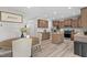 Open kitchen with wood cabinets, stainless steel appliances, center island, and eat-in breakfast nook at 2157 Blue Iris Way, Zebulon, NC 27597