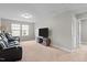 Living room with black leather recliners, carpet flooring, and a media center at 2157 Blue Iris Way, Zebulon, NC 27597