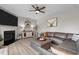 Cozy living room features a stylish fireplace, comfortable leather sofa, and contemporary decor at 2157 Blue Iris Way, Zebulon, NC 27597