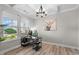 Bright office space with coffered ceilings, stylish chandelier and large window view at 2157 Blue Iris Way, Zebulon, NC 27597