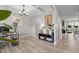 Bright office space with coffered ceilings, stylish chandelier and view of the hallway and kitchen at 2157 Blue Iris Way, Zebulon, NC 27597