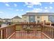 Wooden deck with seating overlooks well-maintained townhomes and landscaping at 228 Dove Cottage Ln, Cary, NC 27519