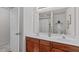 Bathroom showcases dual sinks, wood cabinetry, white countertops, and modern lighting at 228 Dove Cottage Ln, Cary, NC 27519