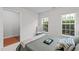 Serene bedroom with natural light, comfortable bed, chair and open doorway at 228 Dove Cottage Ln, Cary, NC 27519