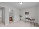 A bedroom with a desk area leading to a bright bathroom with a wooden cabinet and ample space at 228 Dove Cottage Ln, Cary, NC 27519