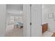 A bedroom seen through a door, adjacent to a bathroom, offering comfortable and private living space at 228 Dove Cottage Ln, Cary, NC 27519