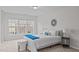 Bright bedroom with a queen-sized bed, modern decor, and large windows overlooking the neighborhood at 228 Dove Cottage Ln, Cary, NC 27519