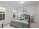 Comfortable bedroom with two large windows, soft carpet, and a cozy bed with stylish decor at 228 Dove Cottage Ln, Cary, NC 27519
