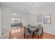 Dining room showcases a chandelier, wood floors, table setting, and an adjoining living room at 228 Dove Cottage Ln, Cary, NC 27519