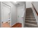 Well-lit entryway boasts staircase, back door access, half bath and luxury vinyl plank flooring at 228 Dove Cottage Ln, Cary, NC 27519