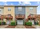 Townhome exterior showcases multiple decks, garages and freshly maintained landscaping at 228 Dove Cottage Ln, Cary, NC 27519