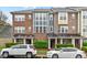 Charming townhomes with brick facade, multiple windows, and manicured landscaping at 228 Dove Cottage Ln, Cary, NC 27519