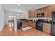Bright, open kitchen with stainless steel appliances, hardwood floors, and seamless integration with the dining area at 228 Dove Cottage Ln, Cary, NC 27519
