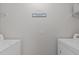 Clean, well-lit laundry room with a modern washer and dryer set at 228 Dove Cottage Ln, Cary, NC 27519