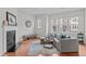 Bright living room features wood floors, stylish decor, lots of natural light and cozy seating at 228 Dove Cottage Ln, Cary, NC 27519