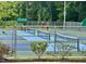 Well-maintained tennis courts surrounded by trees, providing residents recreational opportunities at 228 Dove Cottage Ln, Cary, NC 27519