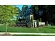 The Varina Gateway community entrance featuring beautiful landscaping, a stone wall, a sign, and green lawns at 2312 Sugar Cone Way, Fuquay Varina, NC 27526