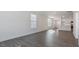 Inviting living area with hard wood floors, white walls, large windows, and a view into the kitchen at 2312 Sugar Cone Way, Fuquay Varina, NC 27526
