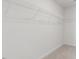 Bright walk-in closet featuring carpet floors and white walls with built-in metal shelving units for optimal storage at 2312 Sugar Cone Way, Fuquay Varina, NC 27526