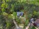 An aerial view of the property highlighting lush trees, expansive lawns, a long drive, and a wooded backyard at 250 Highview Dr, Youngsville, NC 27596
