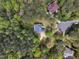 A high aerial view showing the house nestled among mature trees with manicured lawns and long driveways at 250 Highview Dr, Youngsville, NC 27596