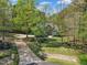 Beautiful home with a long driveway leading to the house, surrounded by lush trees and manicured lawn at 250 Highview Dr, Youngsville, NC 27596