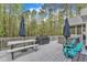 Spacious back deck with picnic table, grill, hot tub, outdoor seating, and wooded view at 250 Highview Dr, Youngsville, NC 27596