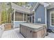 Relaxing back deck with a hot tub, screened in porch and view of the natural backyard at 250 Highview Dr, Youngsville, NC 27596