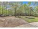 A spacious backyard featuring a lush lawn, mature trees, and a gardening area, perfect for outdoor enjoyment at 250 Highview Dr, Youngsville, NC 27596