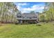 Home exterior with deck overlooking a large, grassy backyard with mature trees at 250 Highview Dr, Youngsville, NC 27596