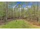 A lovely backyard featuring a fire pit, lush greenery and tall, mature trees at 250 Highview Dr, Youngsville, NC 27596