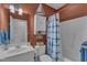 Nautical-themed bathroom with white vanity, white toilet, and tub with blue-and-white curtain at 250 Highview Dr, Youngsville, NC 27596