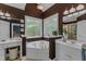 Luxurious bathroom with a garden tub, intricate stained glass window, and elegant lighting fixtures at 250 Highview Dr, Youngsville, NC 27596