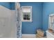 Bathroom with shower and tub combination and a window overlooking the backyard at 250 Highview Dr, Youngsville, NC 27596