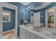 Bathroom with dual sink vanity, a large mirror, and a view to the hall at 250 Highview Dr, Youngsville, NC 27596