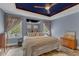 Bright bedroom boasts large windows, natural light, wood floors, and a stylish mirror, creating a relaxing space at 250 Highview Dr, Youngsville, NC 27596