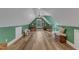 Large bonus room featuring hardwood floors, lots of light, and green walls at 250 Highview Dr, Youngsville, NC 27596