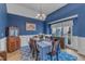Elegant dining room boasting rich blue walls, hardwood floors, and ample natural light at 250 Highview Dr, Youngsville, NC 27596