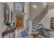 Grand foyer with hardwood floors, a staircase with wrought iron railings, and a decorative front door at 250 Highview Dr, Youngsville, NC 27596