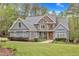Charming two-story home with a stone and siding facade, landscaped yard, and walkway at 250 Highview Dr, Youngsville, NC 27596