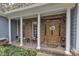 Inviting front porch with brick accents and a welcoming wooden front door at 250 Highview Dr, Youngsville, NC 27596