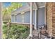 Covered front porch featuring elegant columns and black seating at 250 Highview Dr, Youngsville, NC 27596