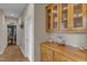 Hallway with beautiful hardwood floors and custom built-in cabinet with glass doors at 250 Highview Dr, Youngsville, NC 27596