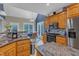 Open kitchen with stainless appliances, granite counters and breakfast nook bathed in natural light at 250 Highview Dr, Youngsville, NC 27596