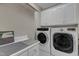 Laundry room featuring a side-by-side washer and dryer, counter space, and upper cabinets at 250 Highview Dr, Youngsville, NC 27596