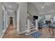 Inviting living room featuring hardwood floors, staircase, and a cozy fireplace, perfect for gatherings at 250 Highview Dr, Youngsville, NC 27596